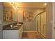 Bathroom boasts a large vanity with granite countertop and shower at 433 Montego Bay Dr, Mulberry, FL 33860