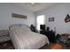 Bedroom with queen-size bed and gray bedding, ceiling fan and TV at 433 Montego Bay Dr, Mulberry, FL 33860