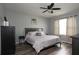 Main bedroom with king-size bed and gray bedding, and ceiling fan at 433 Montego Bay Dr, Mulberry, FL 33860