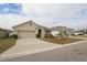 Tan one-story house with attached garage and manicured lawn at 433 Montego Bay Dr, Mulberry, FL 33860