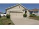 Inviting one-story home with an attached two-car garage and manicured landscaping at 433 Montego Bay Dr, Mulberry, FL 33860