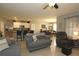 Open living room, gray couch, and view into kitchen and dining areas at 433 Montego Bay Dr, Mulberry, FL 33860