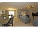 Open living room with gray couch and view into kitchen and dining area at 433 Montego Bay Dr, Mulberry, FL 33860