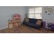 Charming playroom with futon, dollhouse, and ample natural light at 433 Montego Bay Dr, Mulberry, FL 33860