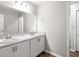 Bathroom featuring a double vanity with white cabinetry, large mirrors, and modern fixtures at 447 Ituna Cir, Winter Haven, FL 33881