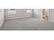 Spacious bedroom featuring soft carpet, ample windows, and easy access to the ensuite bathroom at 447 Ituna Cir, Winter Haven, FL 33881