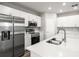 Well-equipped kitchen showcasing stainless steel appliances, white cabinets, and a functional island sink at 447 Ituna Cir, Winter Haven, FL 33881
