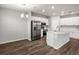 Bright, open kitchen featuring stainless steel appliances, a central island, and modern white cabinetry at 447 Ituna Cir, Winter Haven, FL 33881