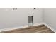This is an empty laundry room with light wood-look flooring and connections for a washer and dryer at 447 Ituna Cir, Winter Haven, FL 33881