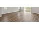 Bright living area with wood-look flooring and sliding glass doors providing ample natural light at 447 Ituna Cir, Winter Haven, FL 33881