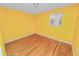 Yellow-walled bedroom with hardwood floors at 514 Mohawk Ave, Lakeland, FL 33815