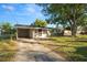 Front view of a house with a carport and yard at 514 Mohawk Ave, Lakeland, FL 33815