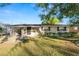 Tan house with carport, landscaping, and a spacious yard at 514 Mohawk Ave, Lakeland, FL 33815