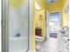 Bathroom with yellow walls, walk-in shower, and access to the backyard at 5171 Deeson Pointe Ct, Lakeland, FL 33805