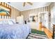 Main bedroom with striped wallpaper, dresser and access to hallway at 5171 Deeson Pointe Ct, Lakeland, FL 33805