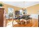 Bright dining room features a rustic wooden table, chandelier, and hardwood floors at 5171 Deeson Pointe Ct, Lakeland, FL 33805