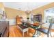 Bright dining room with hardwood floors, a rustic table, and chandelier at 5171 Deeson Pointe Ct, Lakeland, FL 33805