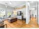 Bright Gathering room with hardwood floors, a large TV, and access to patio at 5171 Deeson Pointe Ct, Lakeland, FL 33805