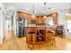 Open kitchen with island, stainless steel appliances, and wood cabinets at 5171 Deeson Pointe Ct, Lakeland, FL 33805