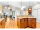 Kitchen island with granite countertop and wood cabinets at 5171 Deeson Pointe Ct, Lakeland, FL 33805