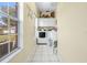 Bright laundry room with washer, dryer, and extra storage at 5171 Deeson Pointe Ct, Lakeland, FL 33805