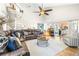 Open living room with spiral staircase, high ceilings, and a leather sectional sofa at 5171 Deeson Pointe Ct, Lakeland, FL 33805