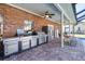 Outdoor kitchen features stainless steel appliances and brick facade at 5171 Deeson Pointe Ct, Lakeland, FL 33805