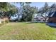 Large grassy side yard with mature trees at 5171 Deeson Pointe Ct, Lakeland, FL 33805