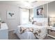 Charming bedroom with a cow print throw and white farmhouse decor at 555 Silver Course Run, Ocala, FL 34472