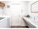 Bright laundry room with washer, dryer, and built-in folding counter at 555 Silver Course Run, Ocala, FL 34472