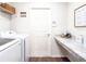 Convenient laundry room with washer, dryer, and built-in folding counter at 555 Silver Course Run, Ocala, FL 34472