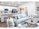 Open-concept living room with kitchen island and seating at 555 Silver Course Run, Ocala, FL 34472