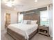 Spacious main bedroom with a large bed and stylish nightstands at 555 Silver Course Run, Ocala, FL 34472