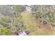 Aerial view shows the property's expansive backyard with a fenced area at 5576 Albert Williams Rd, Mulberry, FL 33860