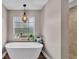 Relaxing bathroom with soaking tub, window, and chandelier at 5576 Albert Williams Rd, Mulberry, FL 33860