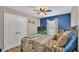 Cozy bedroom with a double bed, blue accent wall, and plenty of natural light at 5576 Albert Williams Rd, Mulberry, FL 33860