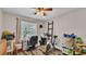 Bright bedroom with a desk, exercise bike, and plenty of natural light at 5576 Albert Williams Rd, Mulberry, FL 33860