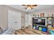 Spacious bedroom with large TV, double doors, and wood floors at 5576 Albert Williams Rd, Mulberry, FL 33860