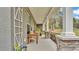Covered porch with stone pillars, wooden bench, and lush landscaping at 5576 Albert Williams Rd, Mulberry, FL 33860