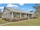 Single story home with front porch and landscaped yard at 5576 Albert Williams Rd, Mulberry, FL 33860