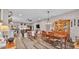 Open living and dining area with hardwood floors, a fireplace, and large windows at 5576 Albert Williams Rd, Mulberry, FL 33860