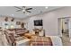 Relaxing living room with sectional sofa, fireplace, and large TV at 5576 Albert Williams Rd, Mulberry, FL 33860