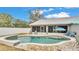 Inviting kidney-shaped pool with a tiled deck and patio furniture at 5576 Albert Williams Rd, Mulberry, FL 33860