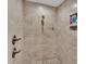 Large walk-in shower with pebble floor and tiled walls at 5576 Albert Williams Rd, Mulberry, FL 33860