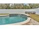 Stunning pool with a tiled water feature and fire pit area at 5576 Albert Williams Rd, Mulberry, FL 33860