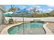 Relaxing kidney shaped pool with patio furniture and umbrellas at 5576 Albert Williams Rd, Mulberry, FL 33860