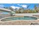 Inviting kidney-shaped pool with brick pavers and water features at 5576 Albert Williams Rd, Mulberry, FL 33860