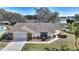 House with a large yard, driveway and lake view at 6004 Greenleaf Cir, Winter Haven, FL 33884