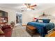 Spacious bedroom with a large bed, ceiling fan, and built-in shelving at 6004 Greenleaf Cir, Winter Haven, FL 33884