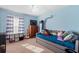 Cozy bedroom with daybed, dresser, and striped curtains at 6004 Greenleaf Cir, Winter Haven, FL 33884